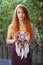 Portrait of lovely slim redhead girl in wine dress and dreamcatcher craft talisman