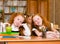 Portrait of lovely twins girls with schoolgirl on background