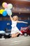 Portrait of lovely young blonde jumps from happiness holding balloons