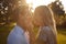 Portrait Of Loving Couple In Countryside Against Flaring Sun