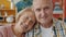 Portrait of loving couple elderly woman and man smiling looking at camera at home