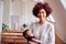 Portrait Of Loving Mother Holding Newborn Baby At Home In Loft Apartment