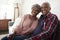 Portrait Of Loving Senior Couple Relaxing On Sofa At Home