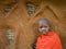 Portrait of a Maasai boy in traditional dress near the house.