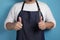 Portrait of male Asian chef or waiter shows thumbs up gesture, proud confident chef shows OK sign