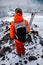 Portrait of a male athlete skier from the back with a backpack and skis on the background of the high mountains of the