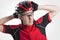 Portrait of Male Caucasian Cyclist Posing in Red Road Protective Helmet and Glasses.