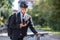 Portrait of a male commuter in a suit and bicycle helmet with a phone.