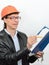 Portrait of male construction worker construction superintendent in glasses protective helmet with a folder of documents and