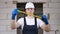 Portrait of a male construction worker in a helmet holding ing a roulette wheel