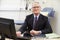 Portrait Of Male Consultant Working At Desk