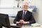 Portrait Of Male Consultant Working At Desk