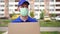 Portrait of a male courier delivery man in a medical mask. Postman in a medical mask