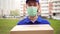 Portrait of a male delivery man courier in a medical mask on his face