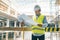 Portrait of male engineer at construction site. Builder looks at the plan of the construction site. Building, development, teamwor