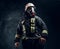 Portrait of a male in full firefighter equipment posing in a dark studio