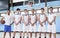 Portrait Of Male High School Basketball Team With Coach On Court