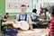 Portrait Of Male High School Student Building Guitar In Woodwork