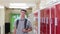 Portrait Of Male High School Student Walking Down Corridor