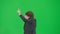 Portrait of male model in suit on chroma key green screen. Handsome young businessman in trendy suit dancing funny disco