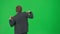 Portrait of male model in suit on chroma key green screen. Handsome young businessman in trendy suit dancing funny disco