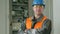 Portrait of a male power engineer, next to an electrical cabinet