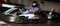 Portrait of male racer in helmet driving kart on track