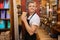 Portrait of male salesperson holding disposable coffee cup in store