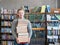 Portrait of a male student with pile books in college library