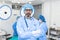 Portrait of male surgeon in operation theater looking at camera. Doctor in scrubs and medical mask in modern hospital operating