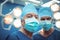 Portrait of male surgeons wearing surgical mask in operation theater