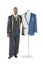 Portrait of a male tailor standing next to a mannequin