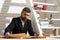 Portrait of male teacher working at desk in class. Tutor, professor, mentor man at desk. Studying, learning, training