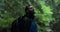 Portrait of a male tourist who stands under the pouring rain