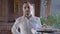 Portrait of male waiter looking at camera walking in slow motion holding tray with dessert and salad and leaving