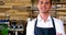 Portrait of male waiter standing with arms crossed