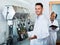 Portrait of male winery worker with bottling machinery on factory