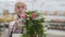 Portrait a Male worker in the agricultural industry holding a young flowers in his hands