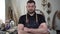 Portrait of a male worker or carpenter in a workshop. Brutal man with a beard