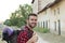 A portrait of a man with backpack giving thumb up isolated on stunning European countryside background with copy space