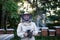 Portrait of man beekeeper working in apiary, holding bee smoker.