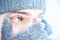 Portrait of a man with blue eyes against a background of falling snow. Beautiful snowy weather. Snowing. Selective focu