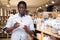 Portrait of man choosing deodorant in dishware store