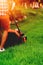 Portrait of man cutting the lawn, cutting the grass in backyard. Gardening and landscaping