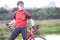 Portrait of Man Cyclist Relaxing with Road Bicycle Outdoors