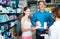 Portrait of man with daughter teenager shopping medicine in drug