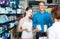 portrait of man with daughter teenager shopping medicine in drug store