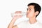 Portrait of a man drinking purified water from bottle on white background. purified water is good for health to protect people