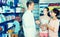 Portrait of man druggist in white coat giving advice to customer