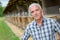 Portrait man in front barn